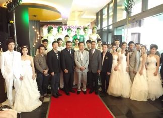 Honored guests pose with the models after the wedding dress fashion show at the Tsix5 Hotel.